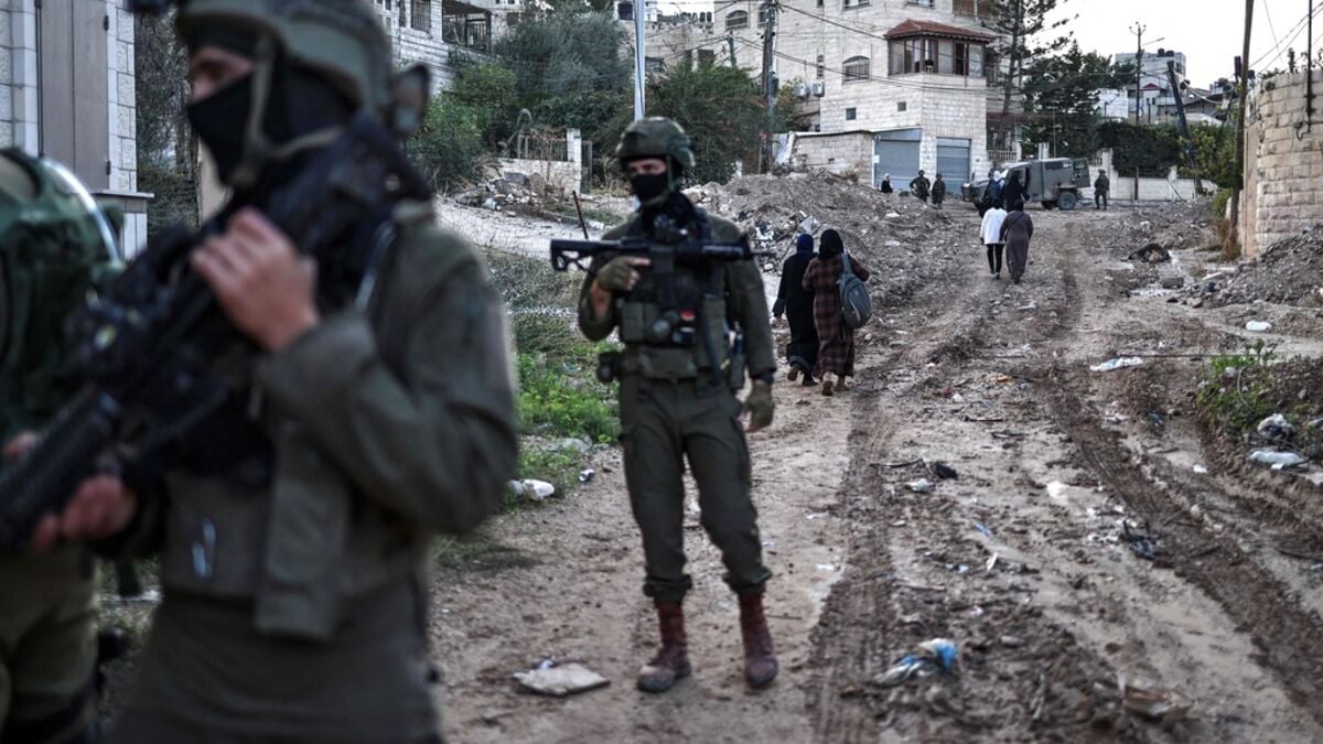 Palestinians shot with their hands outstretched