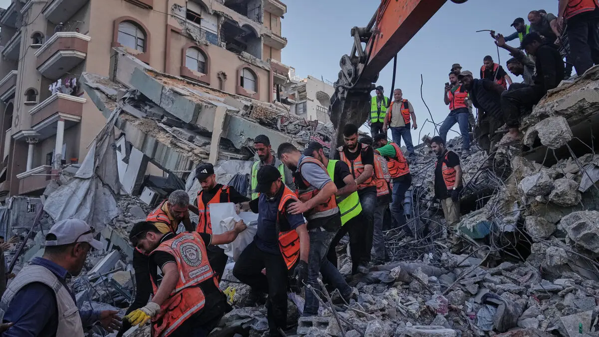 Damaged apartment building collapses in Gaza, leaving at least 14 dead and many missing