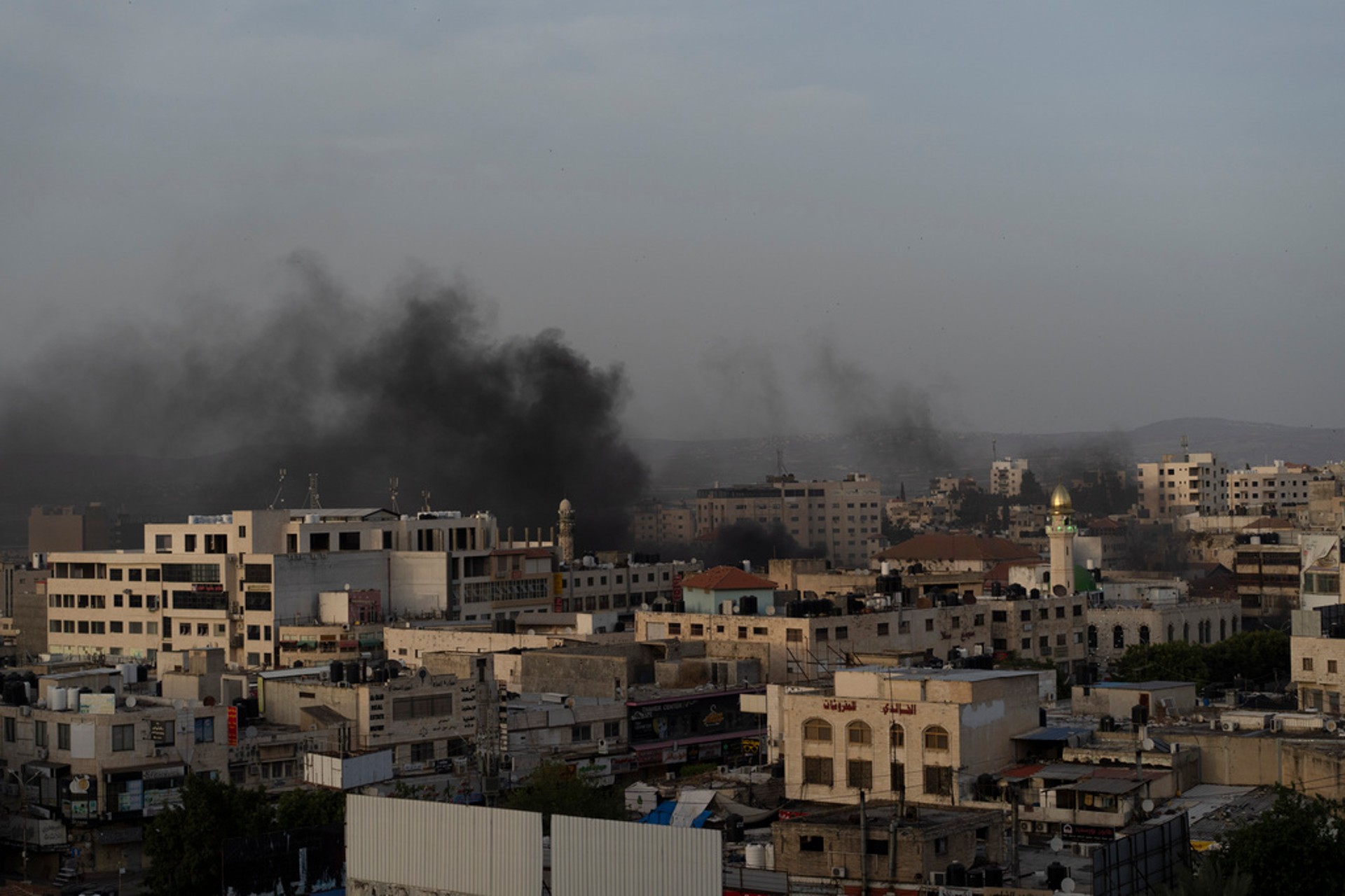 Palestinian man pinned down on car bonnet during raid