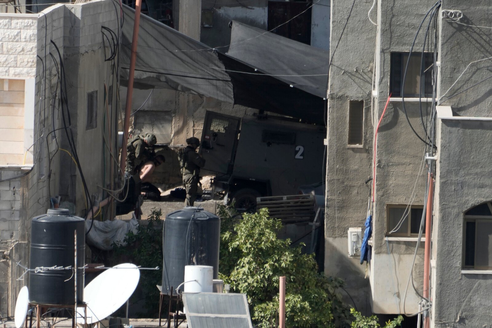 Israeli soldiers pushed bodies off a rooftop