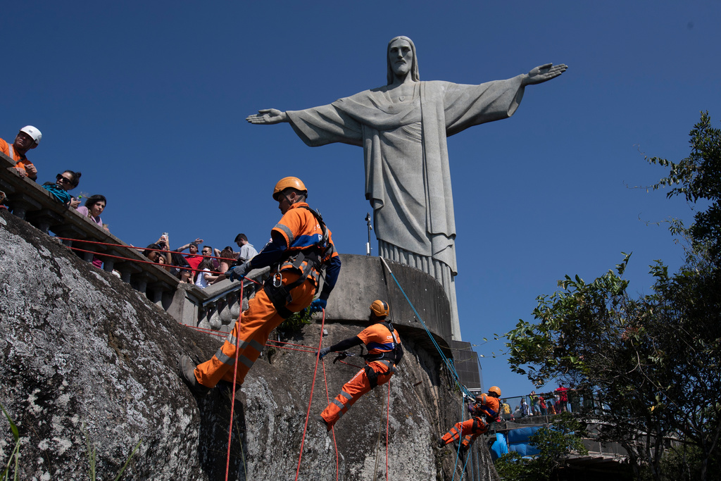 Climbers clean up around Jesus in Rio